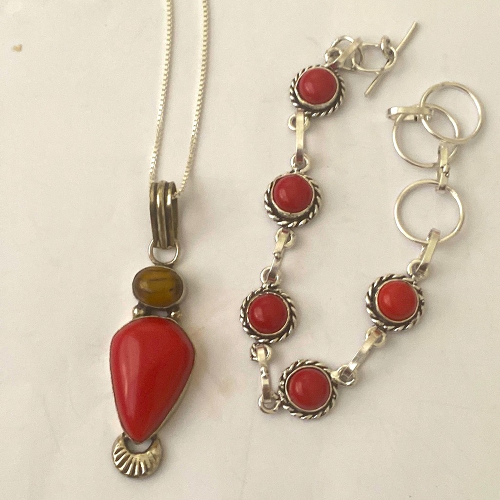 Coral and tigers eye 1 1/2 inch pendant on a chain . Coral adjustable bracelet